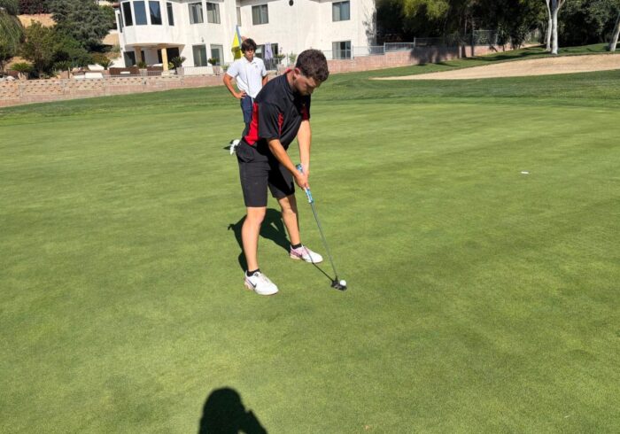 Agundez setting up to address the ball, on a golf course